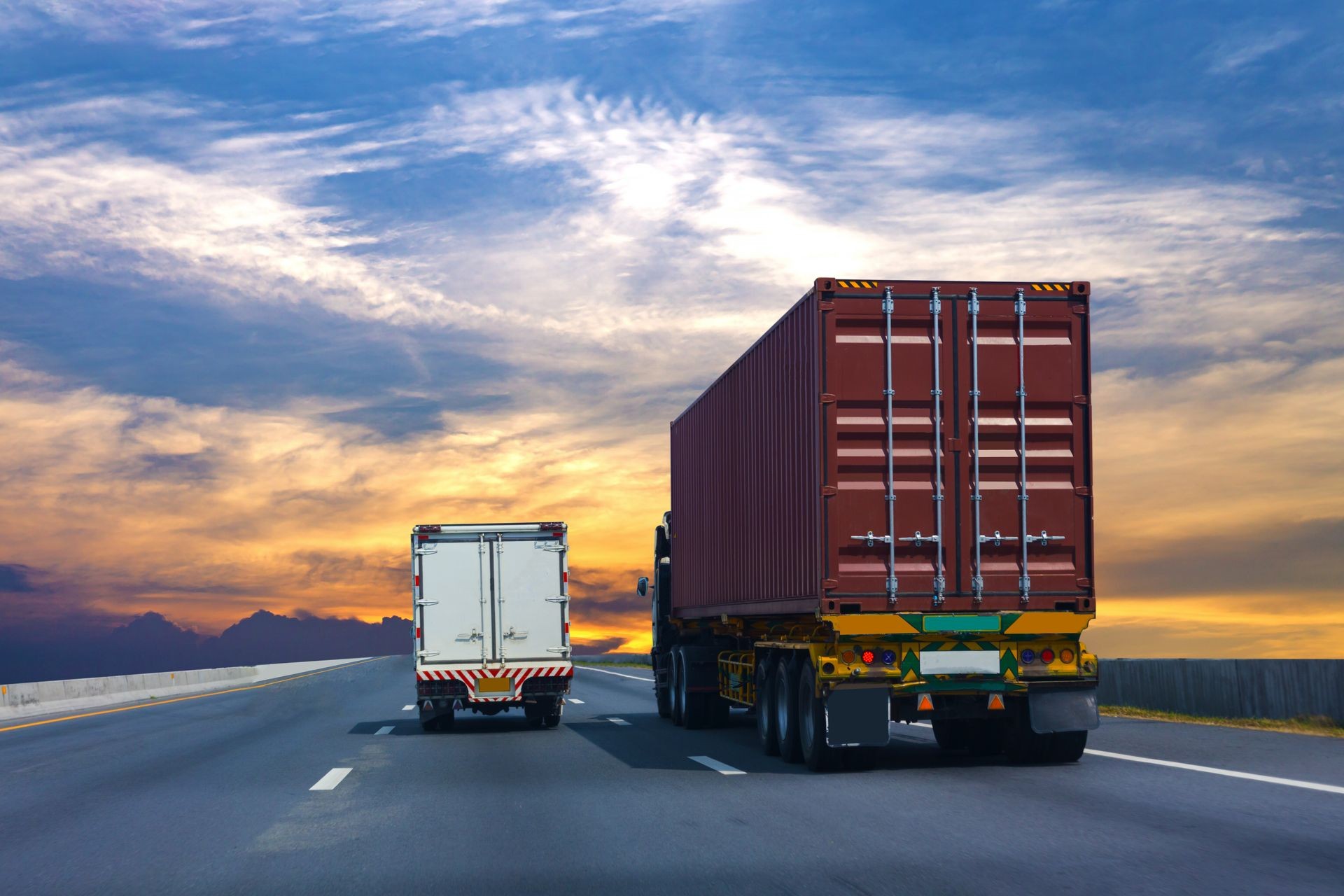 Truck on highway road with red  container, transportation concept.,import,export logistic industrial Transporting Land transport on the asphalt expressway Against Sky During Sunset